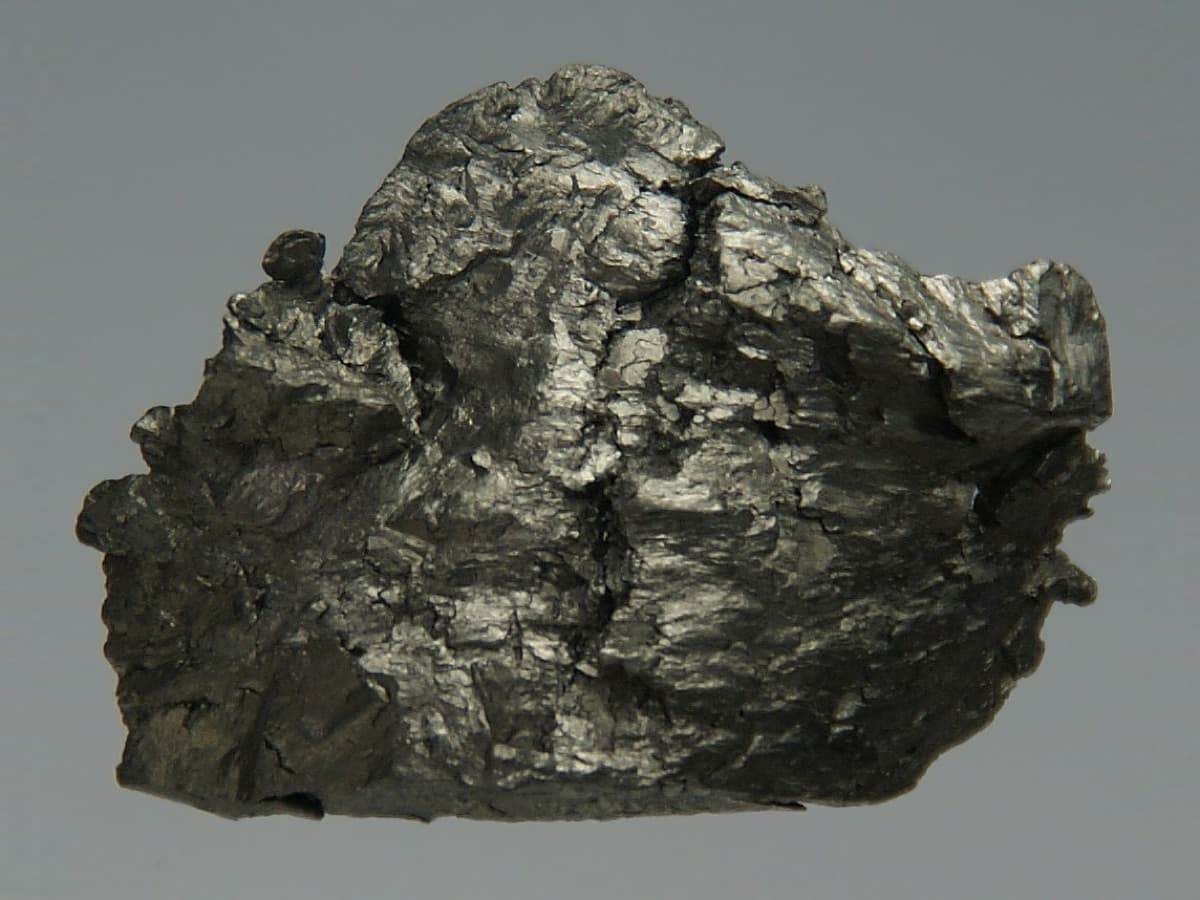 Pure (99.95%) Amorphous Gadolinium, about 12 grams, 2 × 1.5 × 0.5 cm, cast in acrylic glass