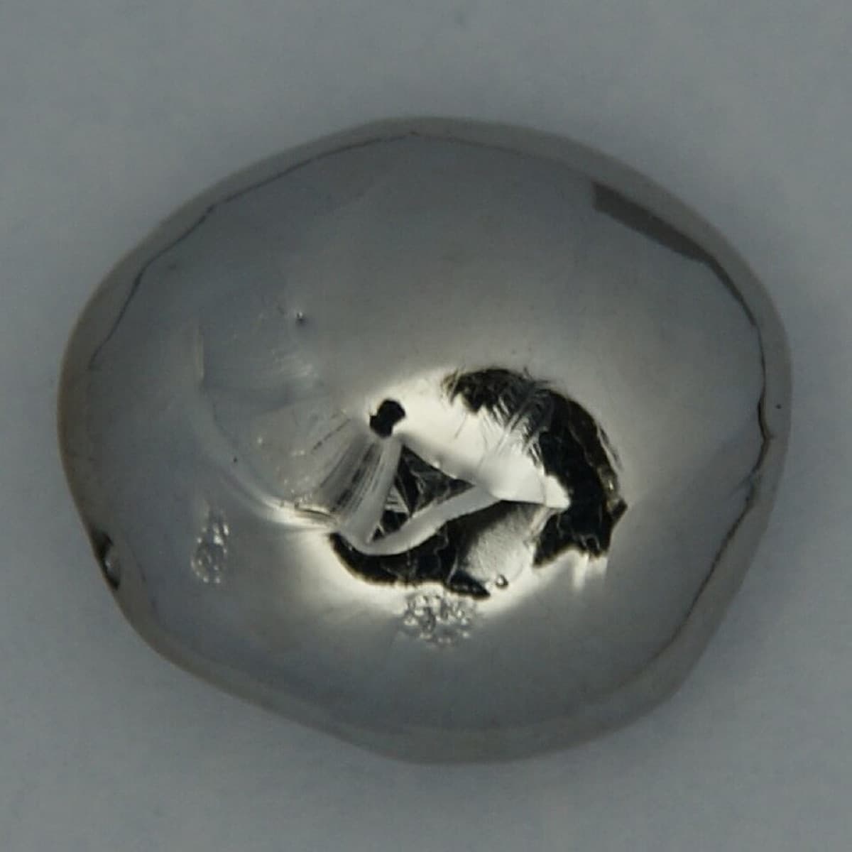 Pure Rhenium Bead, arc melted, 21 grams. Original size in cm: 1.5 x 1.7. Measured radiation dose <0.05 μS/h.