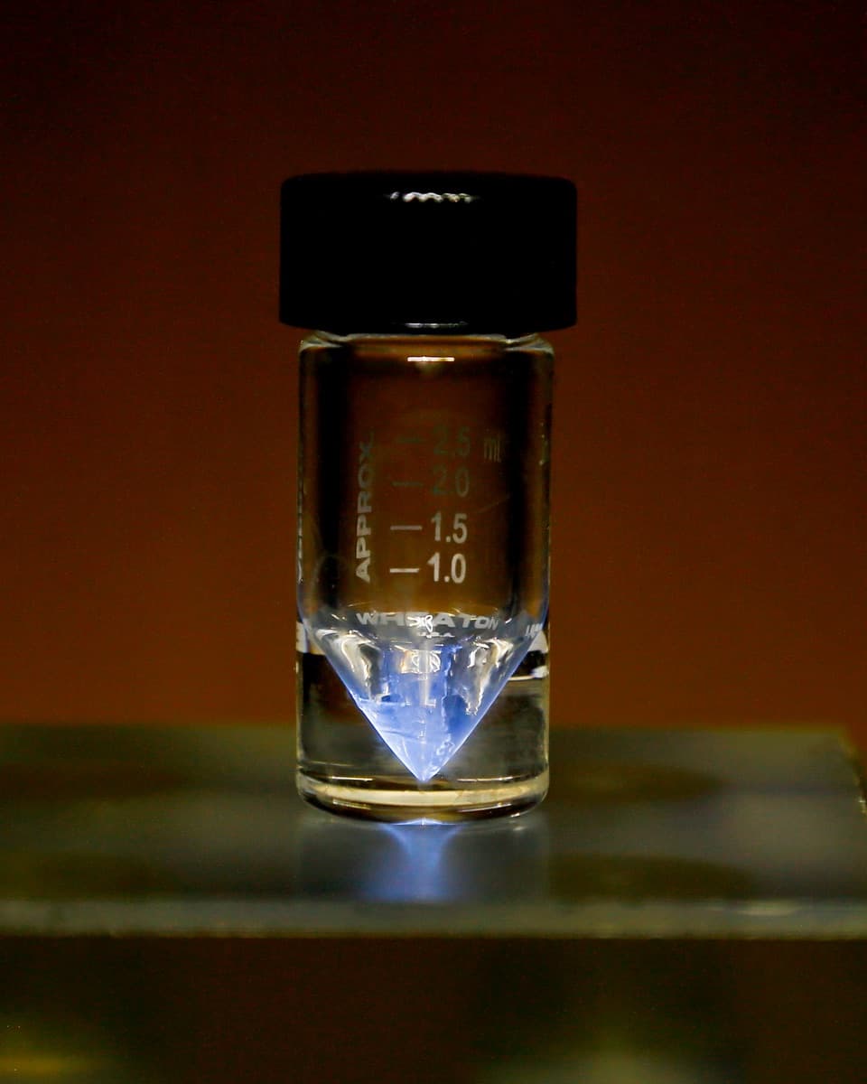 Actinium-225 medical radioisotope held in a v-vial at ORNL. The blue glow comes from the ionization of surrounding air by alpha particles